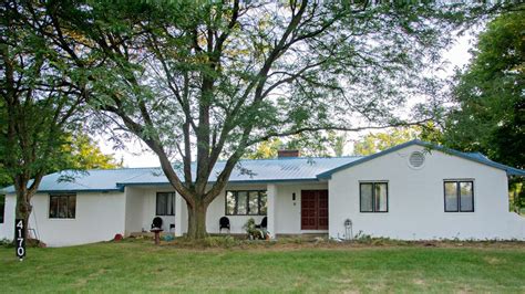 white painted brick house with metal roof|pictures of brick house roofs.